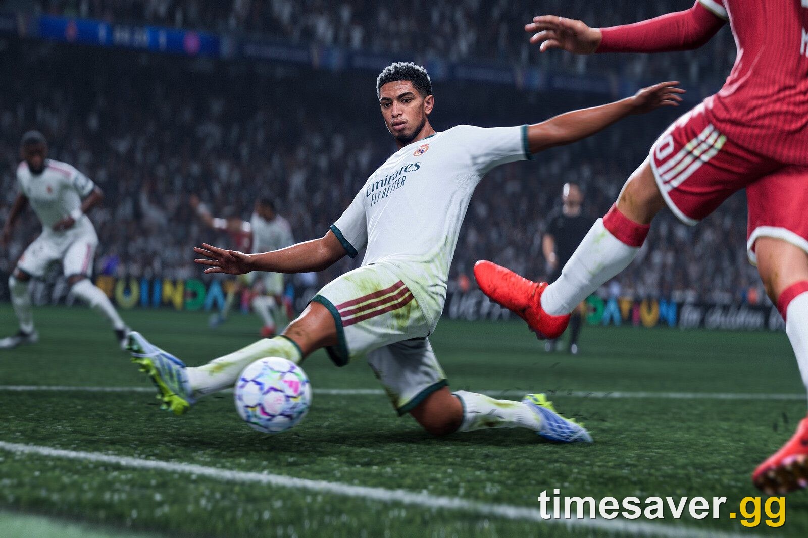 EA SPORTS FC 27 match action as a Real Madrid player in white slides in to play the ball under pressure from two defenders in red